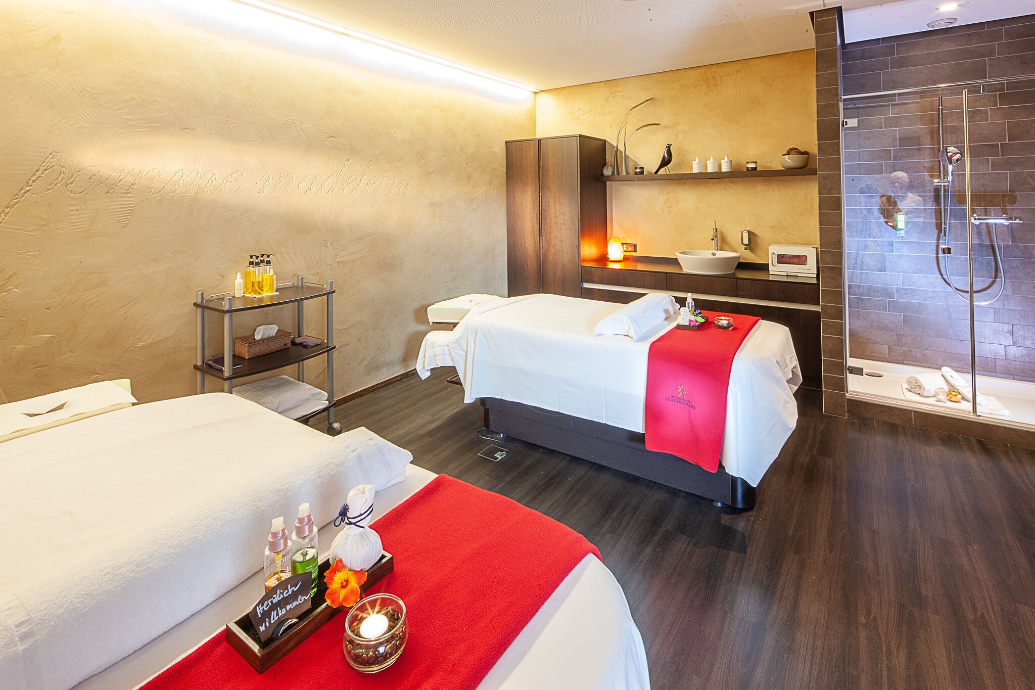 A hotel room with two beds, a bathroom, and a small table with toiletries.