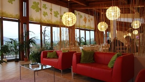 A modern living room with a red sofa, glass coffee table, and decorative lighting. - aCasaMia Wine Resort - Borgo Salella (San Cipriano Picentino)