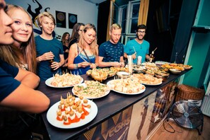 A group of people gathered around a buffet table with various dishes.