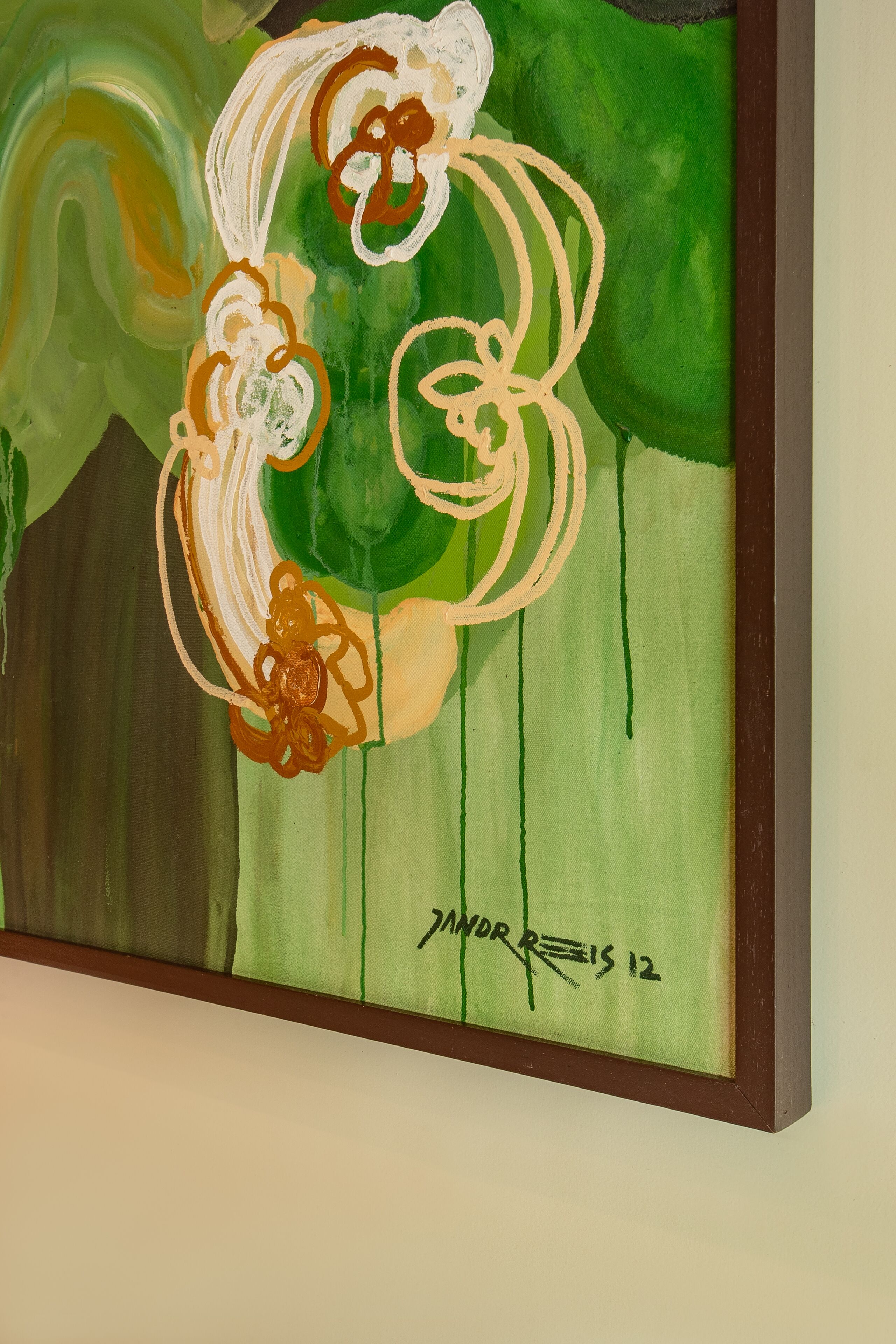 A framed abstract painting with swirling patterns and a signature.