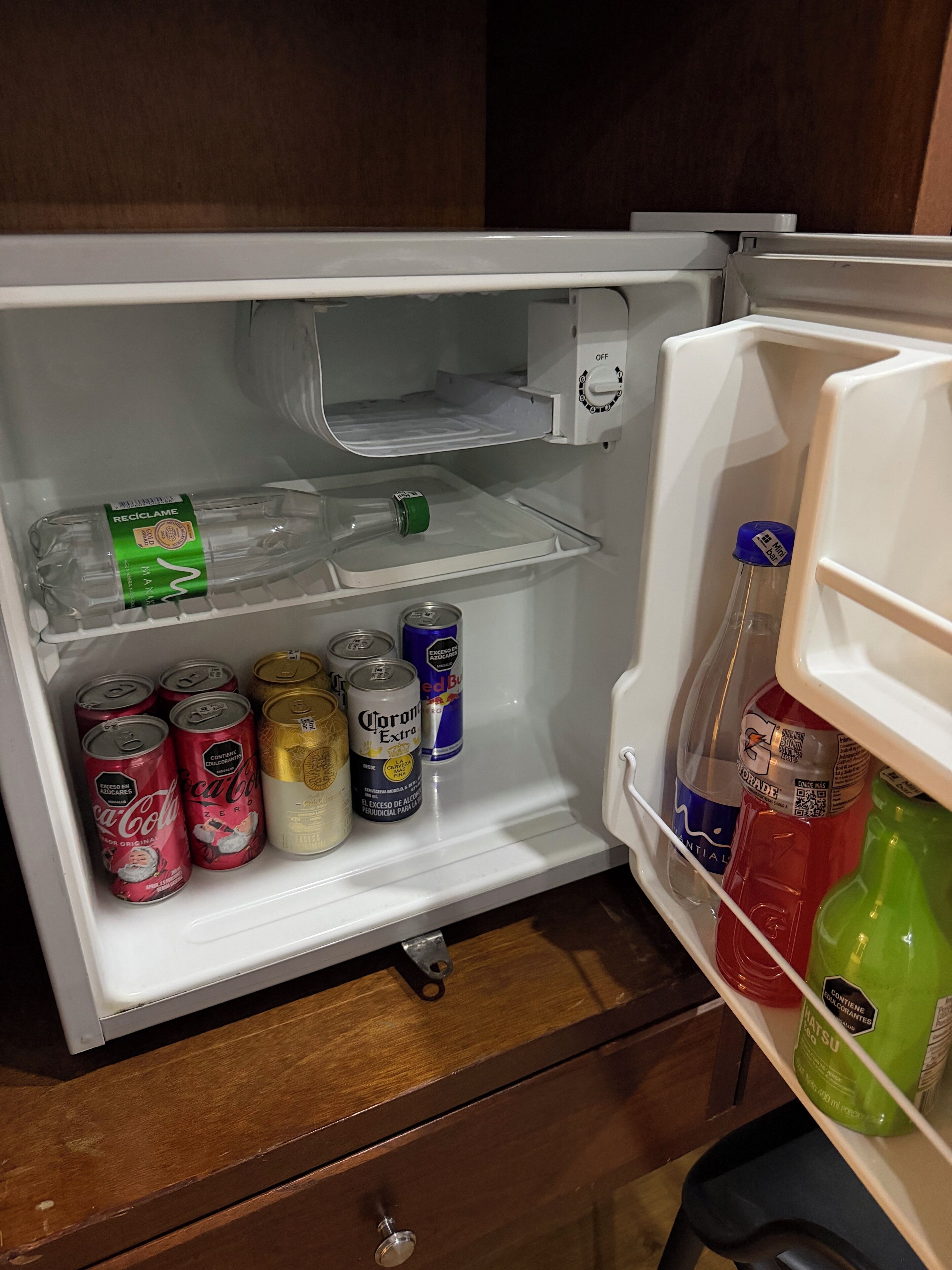 An open refrigerator with various beverages and cans.