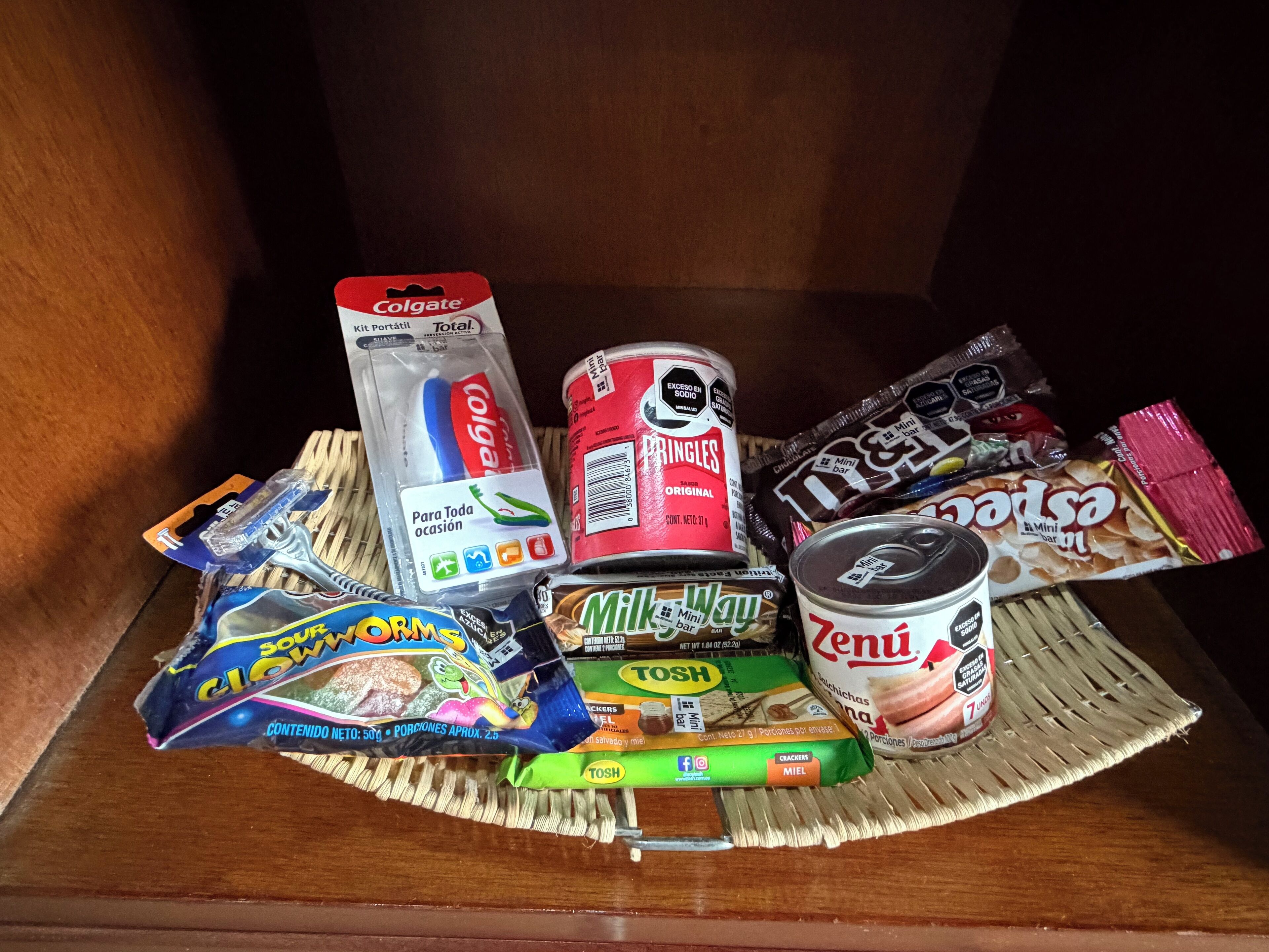 A variety of snacks and personal care items on a wooden surface.