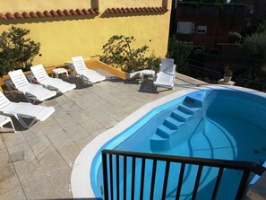 Seasonal outdoor pool, pool loungers
