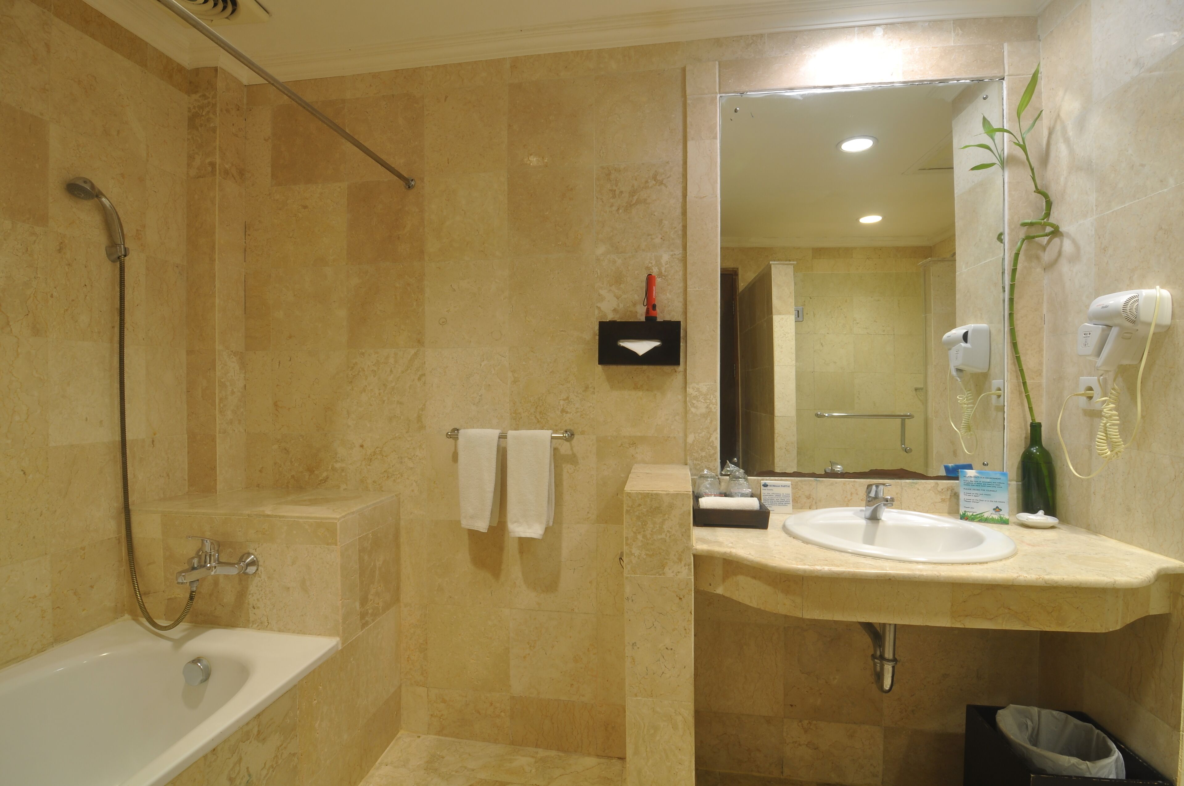 Une salle de bain avec une baignoire, un lavabo, un miroir et une douche.