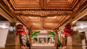 An ornate entrance with intricate carvings, a central statue, and red lanterns. - Hotel Kumala Pantai (Legian)