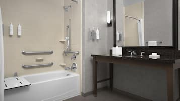 A modern bathroom with a bathtub, shower, and vanity.