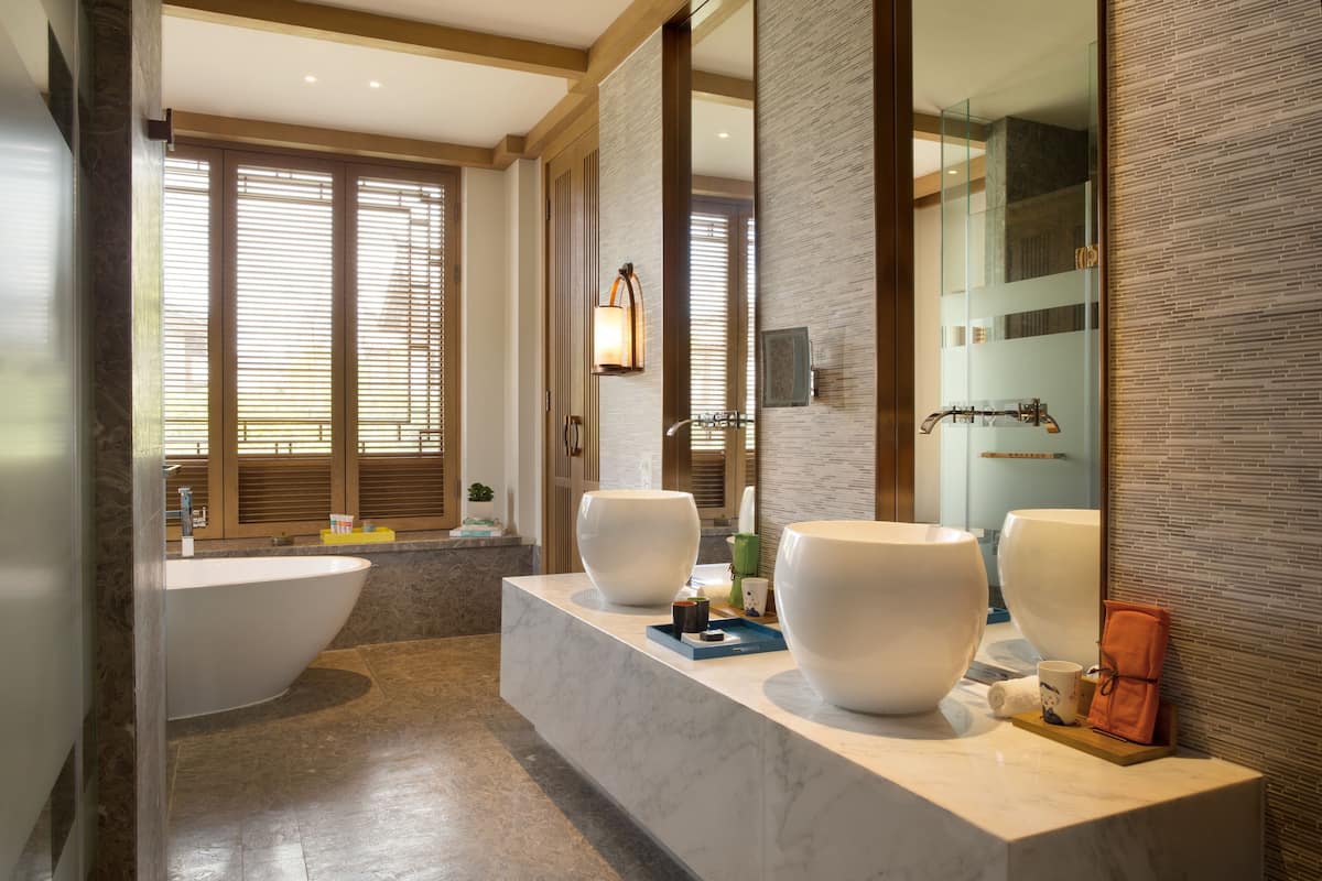 separate bathtub and shower, rainfall showerhead, designer toiletries