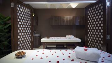 Relax in style with a spacious bed, a massage table, and thoughtful touches like a sweet treat.