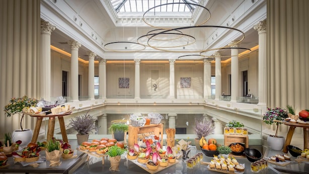 A luxurious atrium with high ceilings, classical columns, and a central glass floor. - Radisson Blu Hotel Nantes (Nantes)