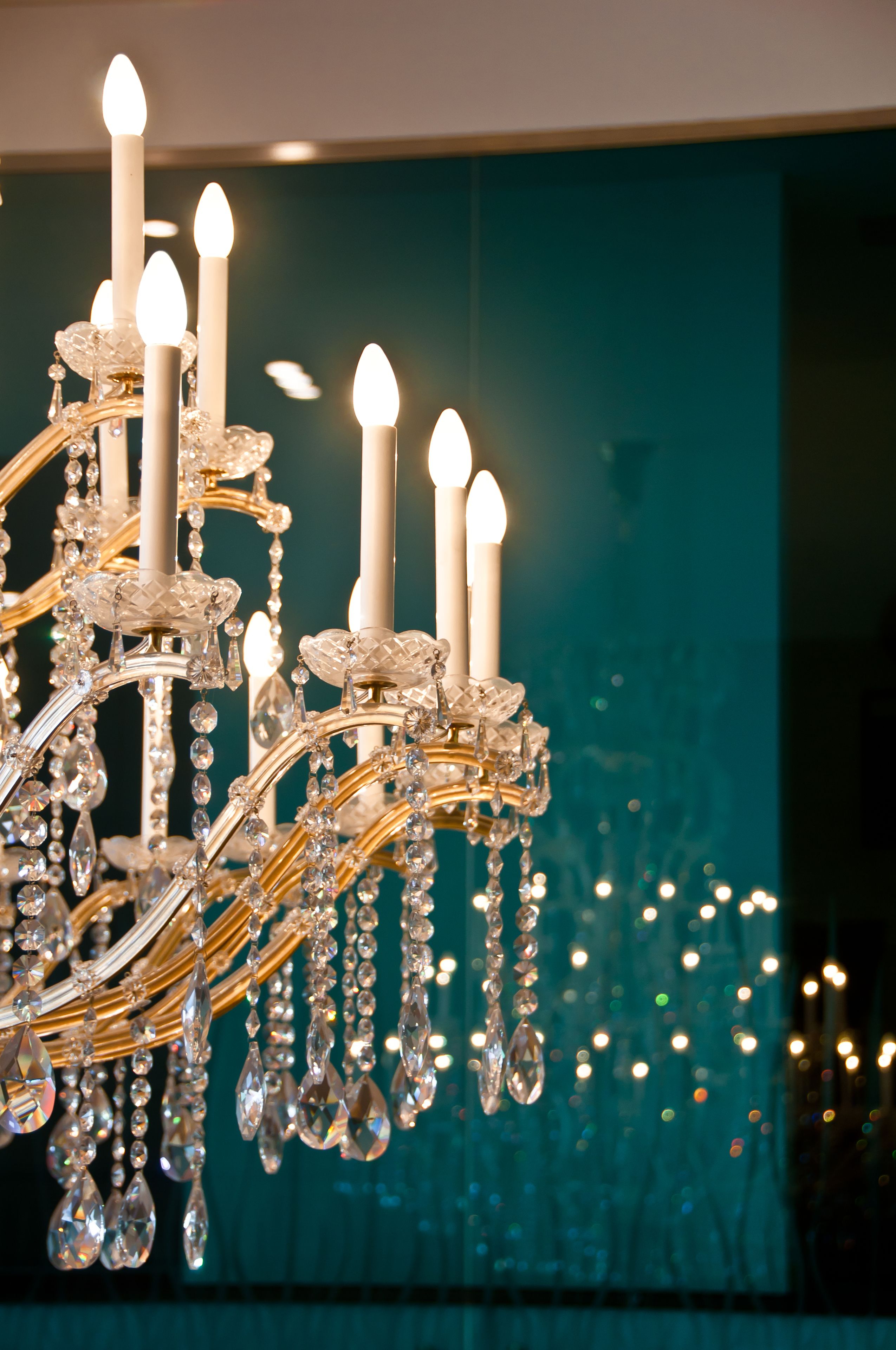 A chandelier with multiple candle-like lights and crystal decorations.