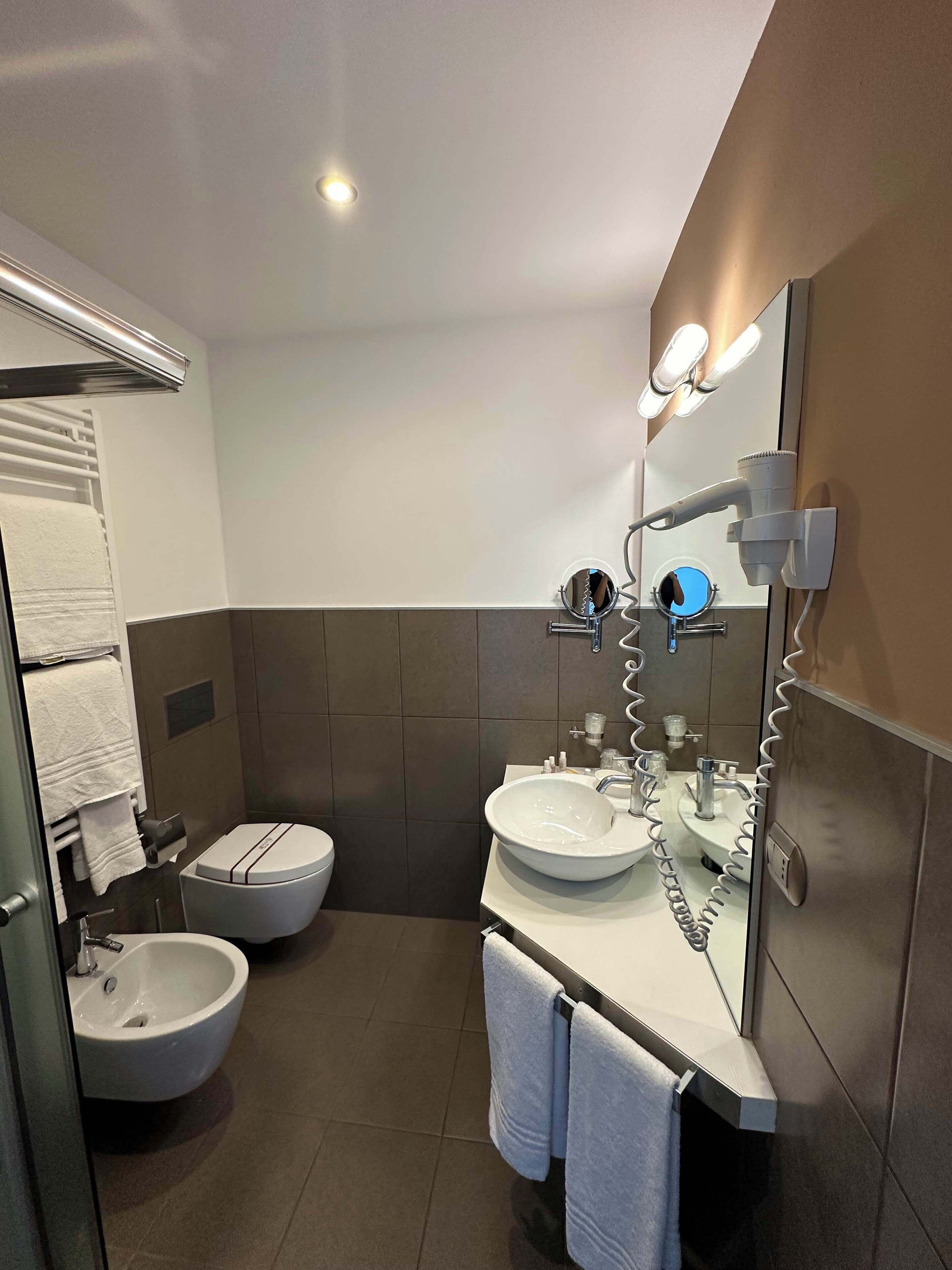 shower, hair dryer, slippers, towels