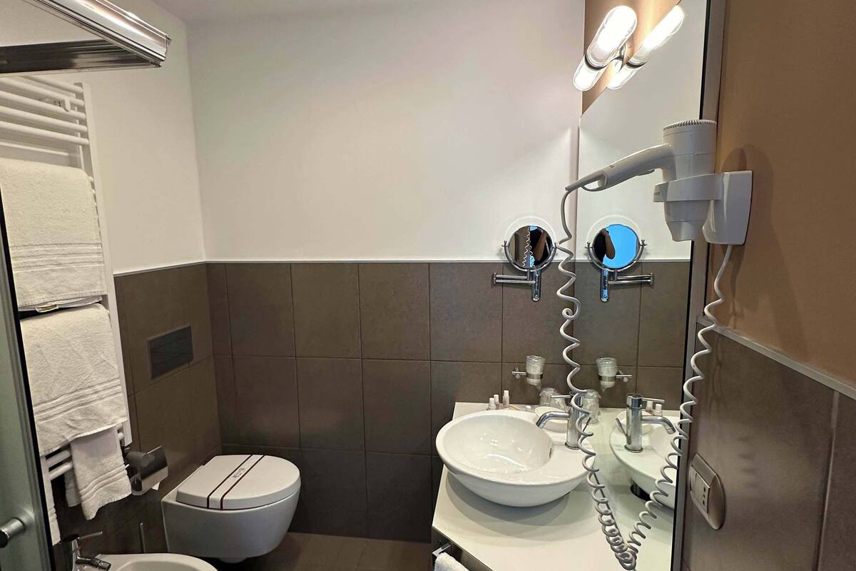 shower, hair dryer, slippers, towels