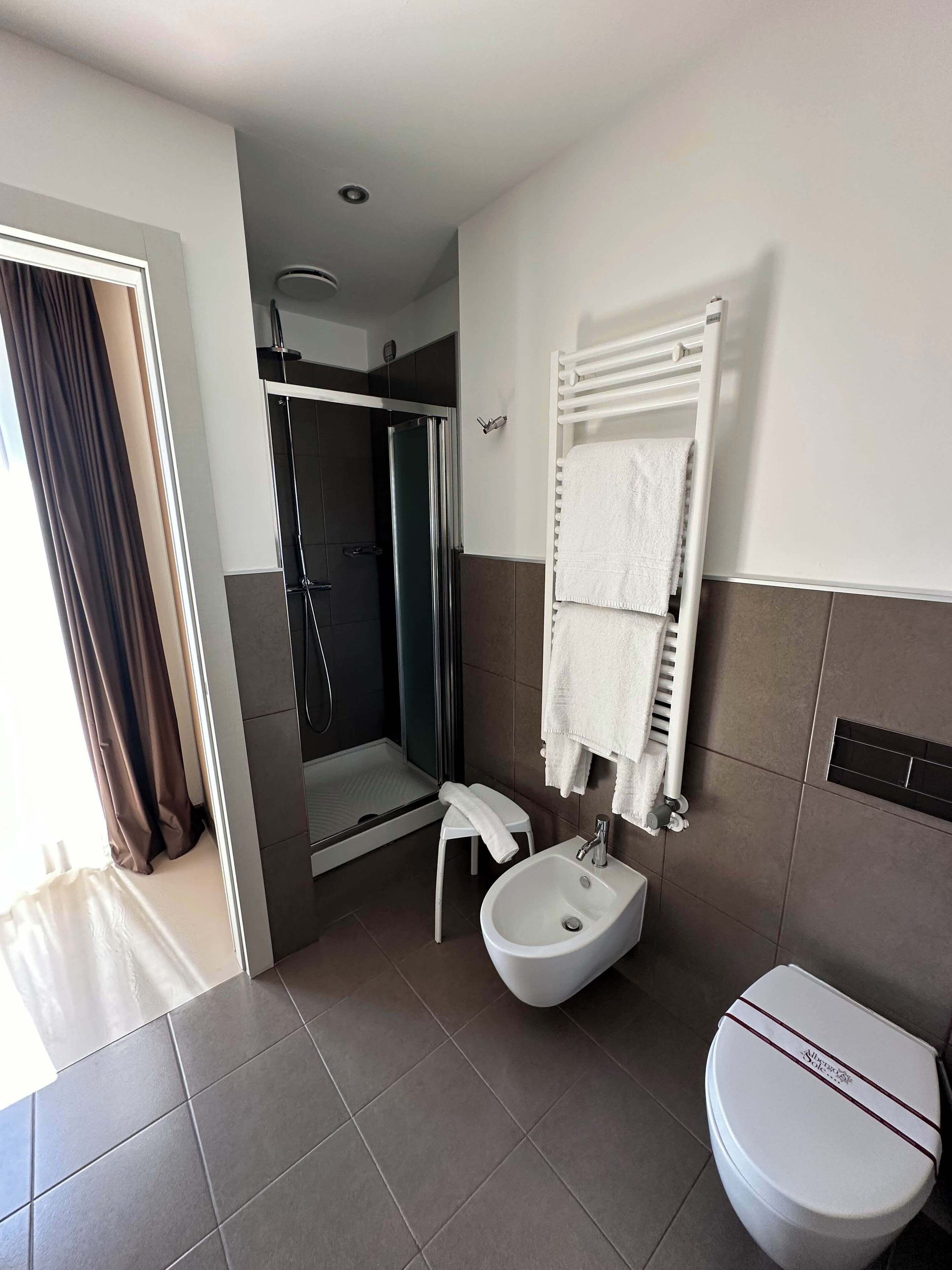 shower, hair dryer, slippers, towels