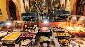 A buffet with various food options including pasta, salads, and desserts. - Regenta MPG Club (Mahabaleshwar)
