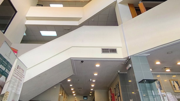 A multi-level interior with a central staircase, recessed lighting, and a hexagonal ceiling design. - Jubilee Hotel (Bandar Seri Begawan)