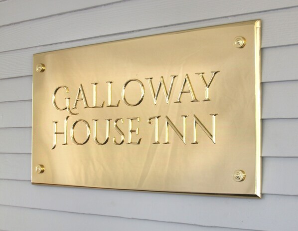 A brass sign with the text "Galloway House Inn" mounted on a light-colored wall. - The Galloway House Inn (Savannah)