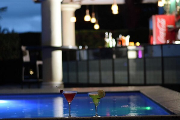 A poolside area with two cocktails and a Coca-Cola cooler in the background. - Hotel Centro Puerto Princesa, Palawan (Puerto Princesa)