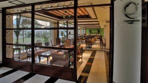 A traditional Japanese-style interior with tatami mats, low wooden tables, and a view through a shoji screen. - Hotel Centro Puerto Princesa, Palawan (Puerto Princesa)