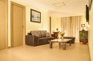Suite, 3 Bedrooms | Living room | 46-inch plasma TV with cable channels, TV