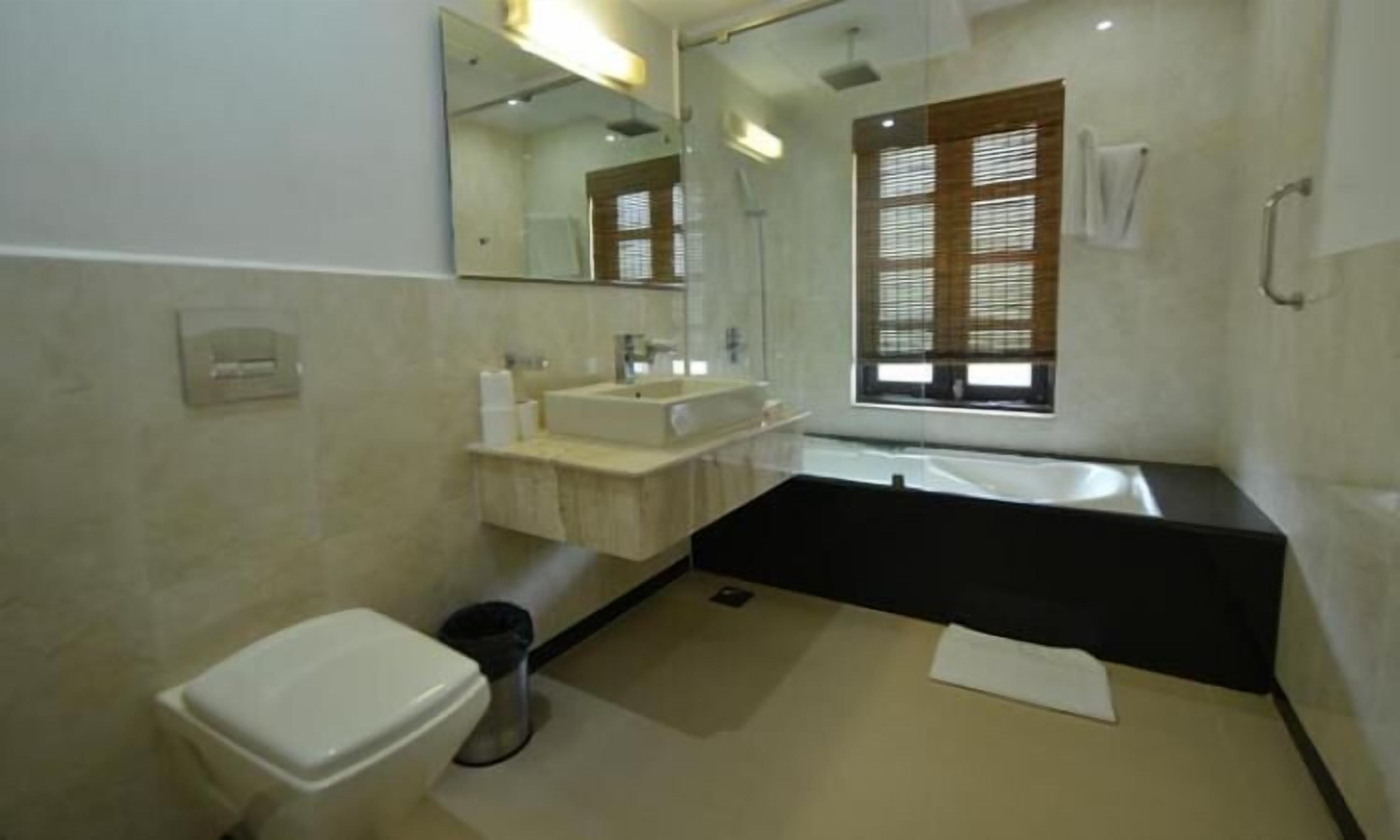 Un baño moderno con inodoro, lavamanos y bañera.