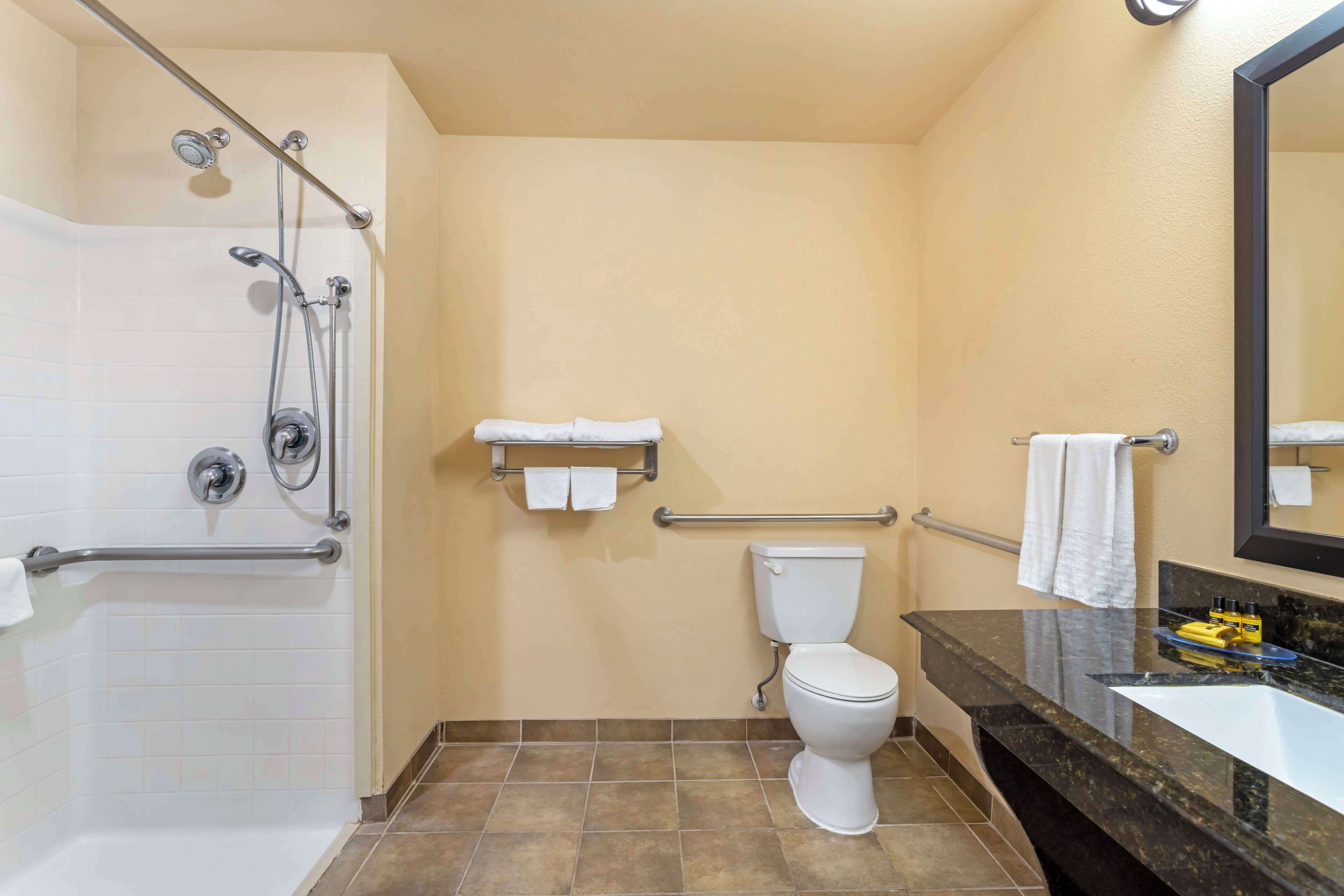 A bathroom with a bathtub, a toilet, a sink, and a shower.