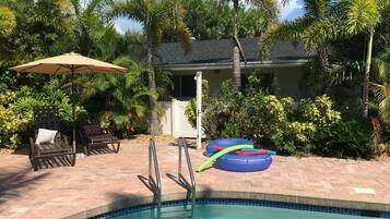 Outdoor pool, a heated pool, pool umbrellas, pool loungers