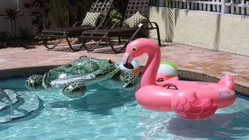 Relax by the pool with a fun view of the surrounding deck and lounge chairs.