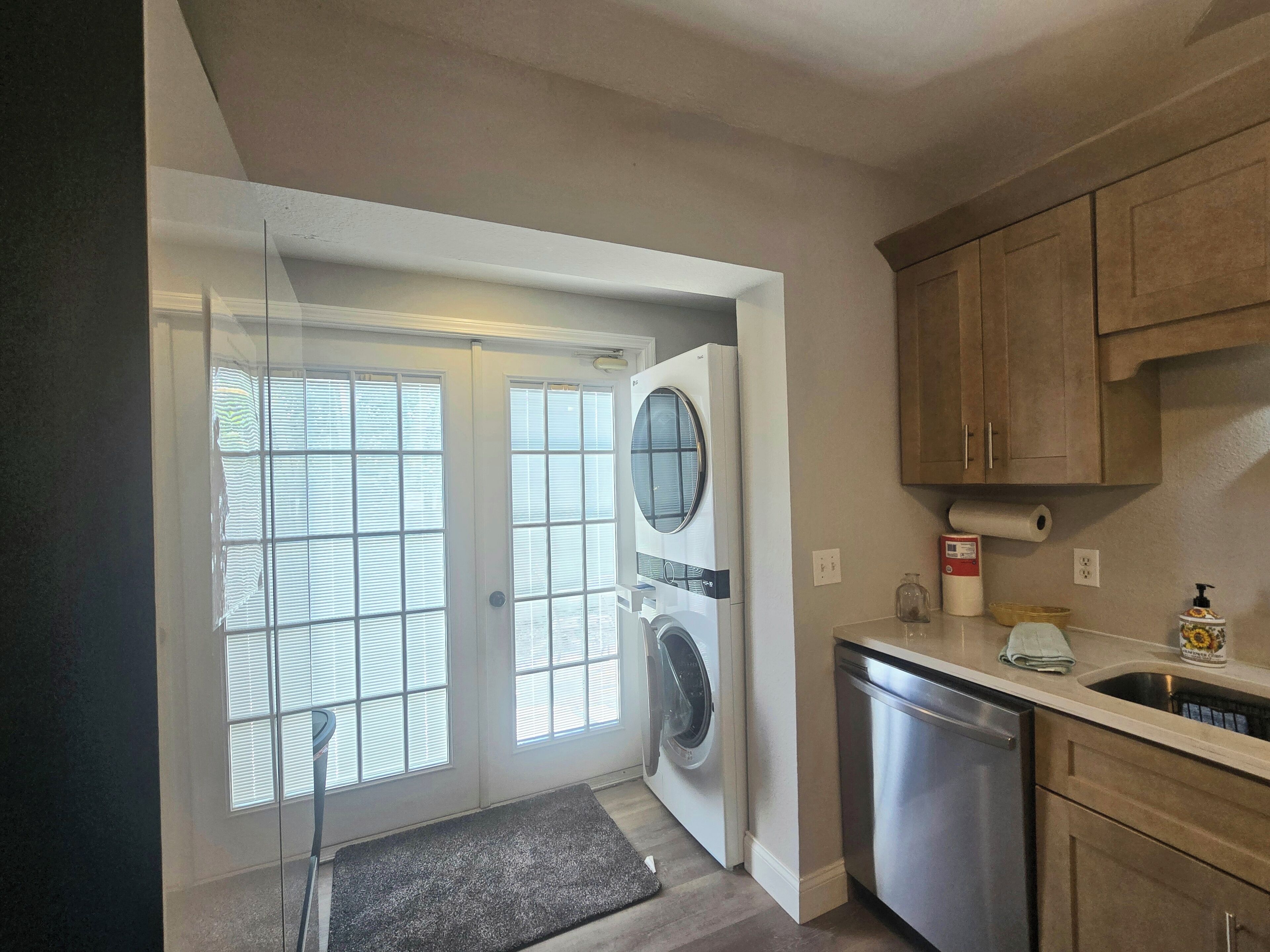 A laundry room with a washing machine, dryer, and dishwasher.