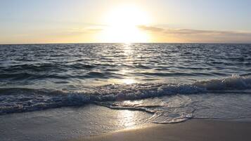 Beach nearby, white sand, beach umbrellas, beach towels