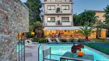 Outdoor pool, a lap pool, open 8:00 AM to 7:30 PM, pool loungers