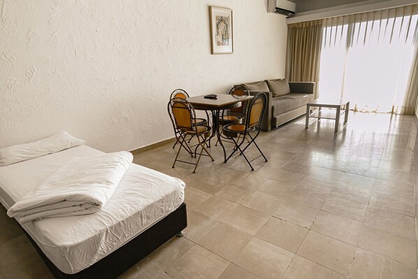 Comfort Apartment | Living area | 32-inch flat-screen TV with satellite channels, TV
