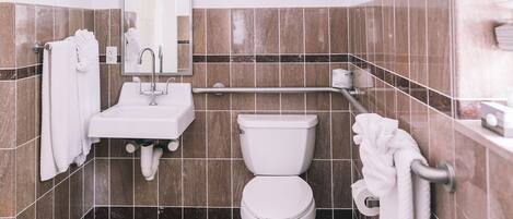 A bathroom with a white sink, a toilet, and a mirror.