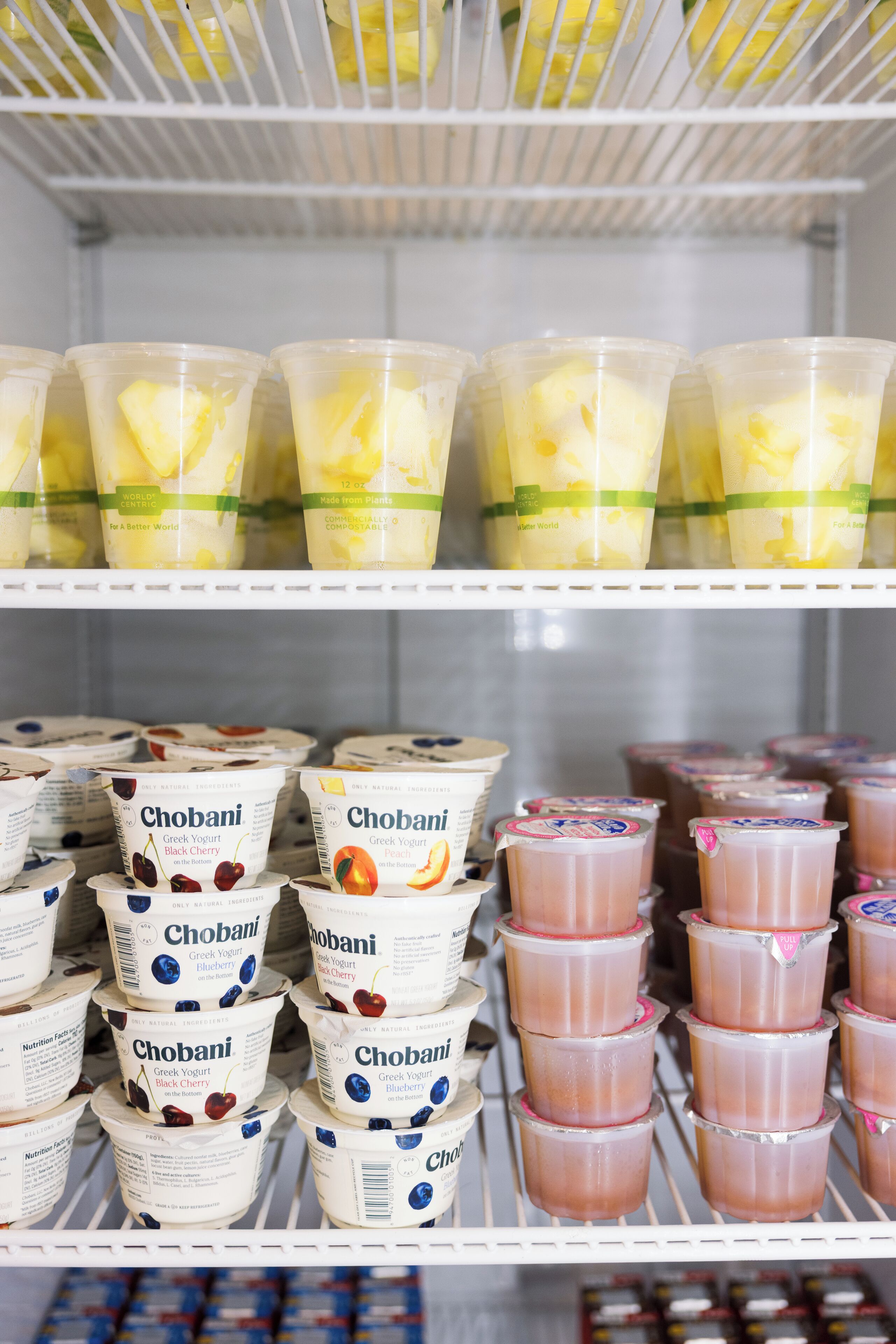 A refrigerated display of Chobani Greek yogurt in various flavors.