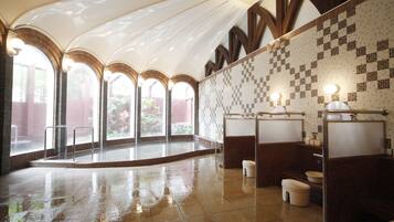 Spacious bathroom with high ceilings, arched windows, and a clean, contemporary aesthetic.