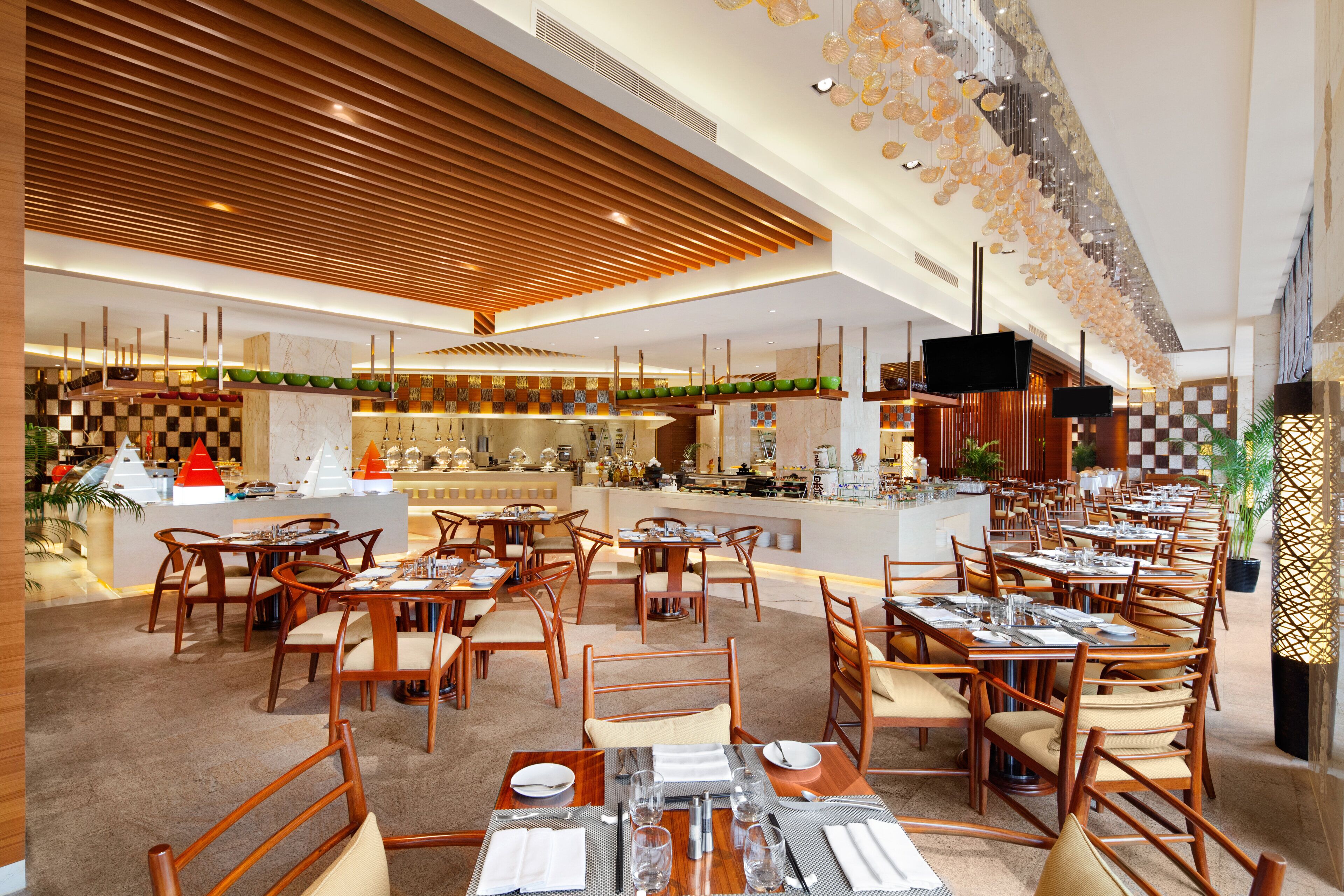 A spacious restaurant with wooden furniture and a modern design.