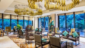A spacious lobby with modern furniture, large windows, and a unique chandelier. - Crowne Plaza Sanya City Center by IHG (Sanya)