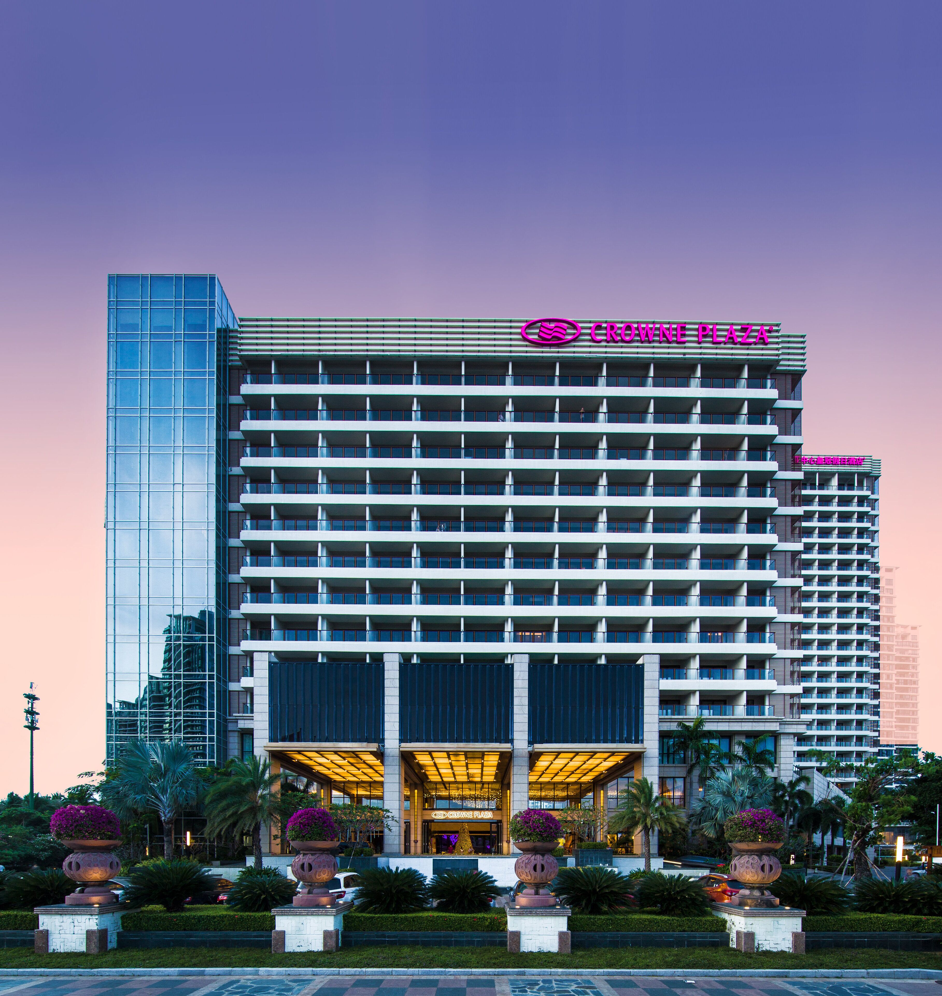 A multi-story hotel with a prominent glass facade and a flat roof.