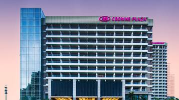 A multi-story hotel with a prominent glass facade and a flat roof.