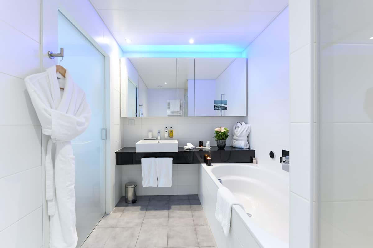 separate bathtub and shower, deep-soaking bathtub, rainfall showerhead