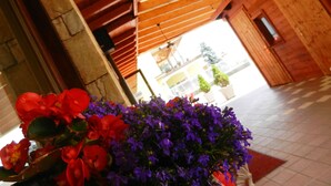 A wooden staircase with a view of a building outside. - Hotel Albergo Al Milano (Bossico)