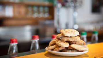 A plate of flatbreads stacked on a table with a yellow tablecloth.