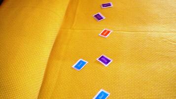 A yellow fabric with small, rectangular, color-coded labels.