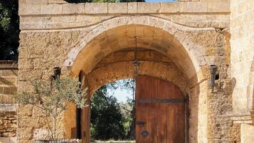 Enter through the historic stone archway to a traditional setting.