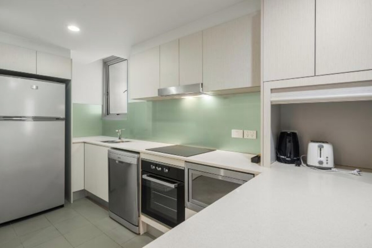 A modern kitchen with stainless steel appliances, a dishwasher, and a toaster.