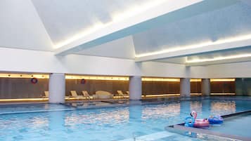Relax by the pool with lounge chairs and a lifebuoy nearby.