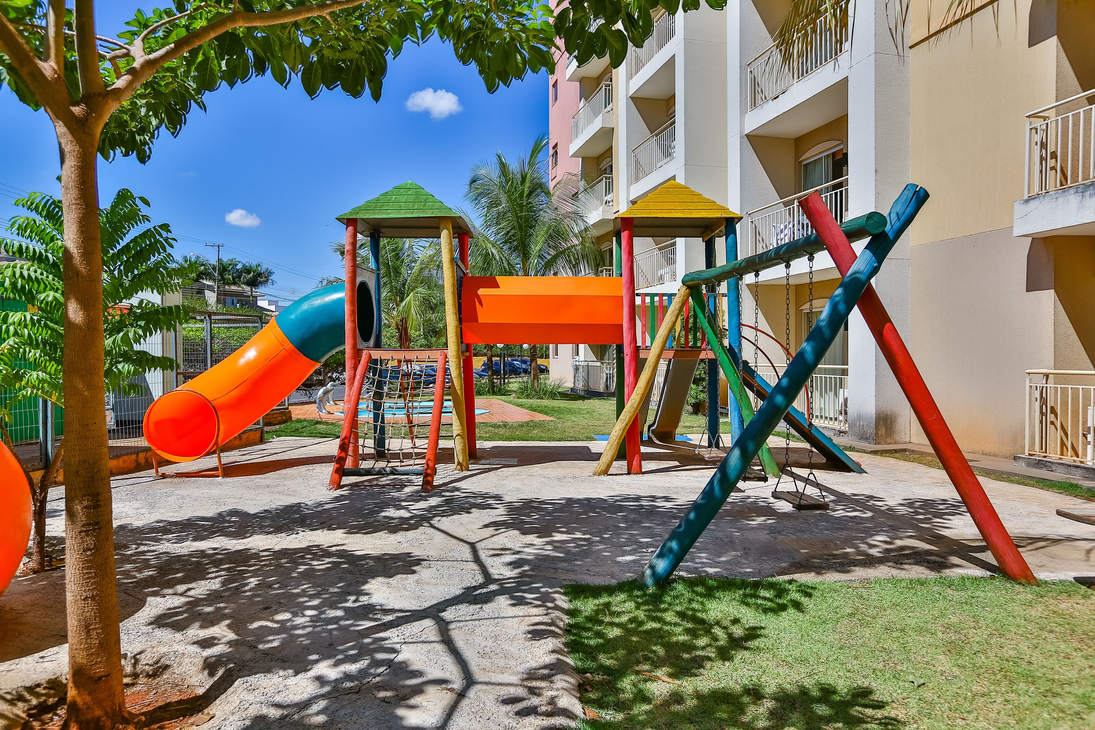 A playground with a slide, swings, and a climbing structure.