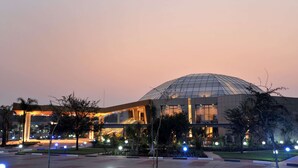 A modern building with a large glass dome and a well-lit entrance area. - Radisson Blu Hotel Lusaka (Lusaka)