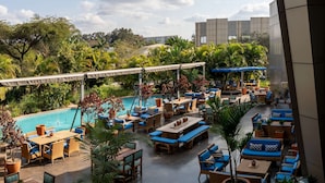 A rooftop pool area with lounge seating and potted plants. - Radisson Blu Hotel Lusaka (Lusaka)