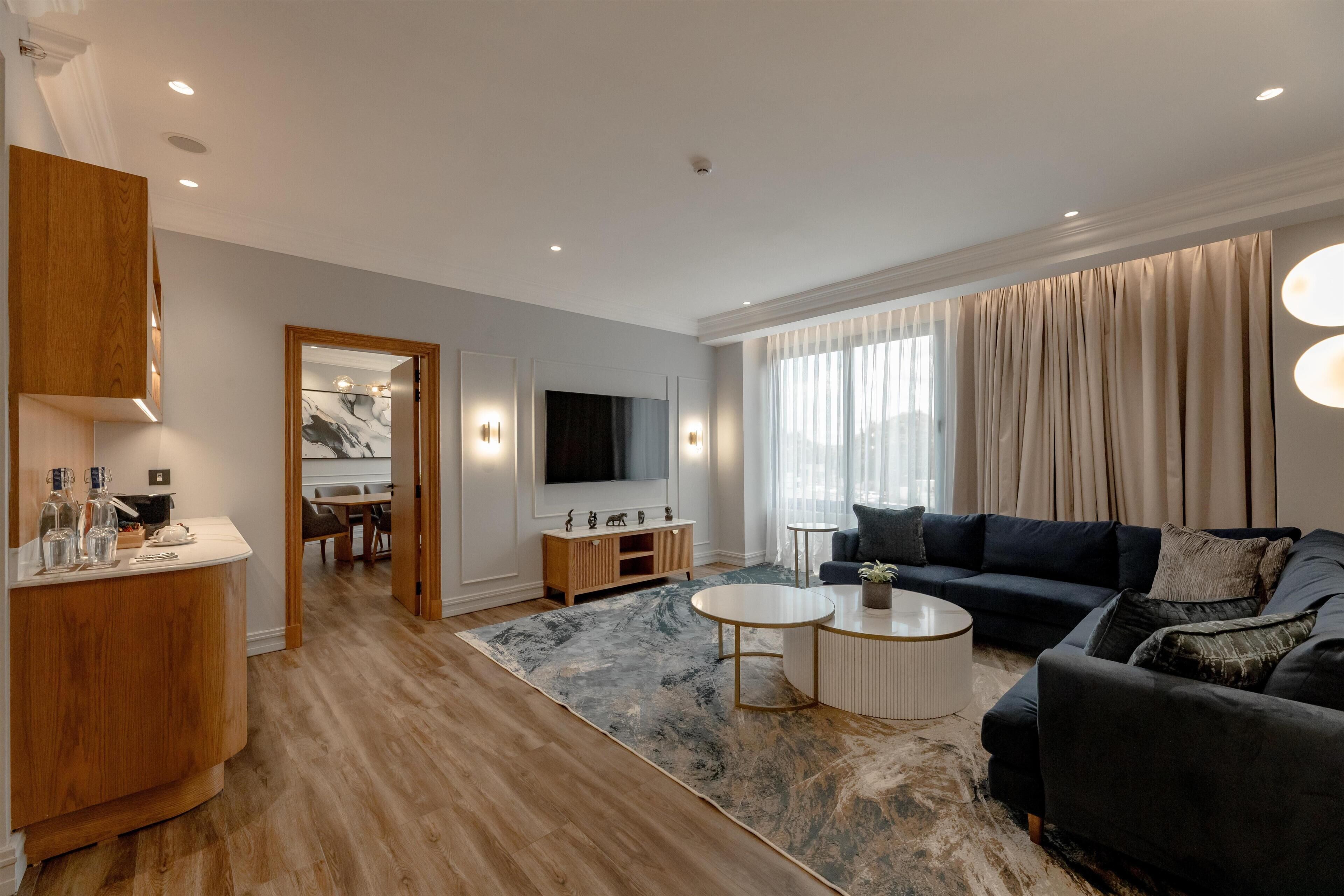 A modern living room with a sofa, coffee table, and TV.