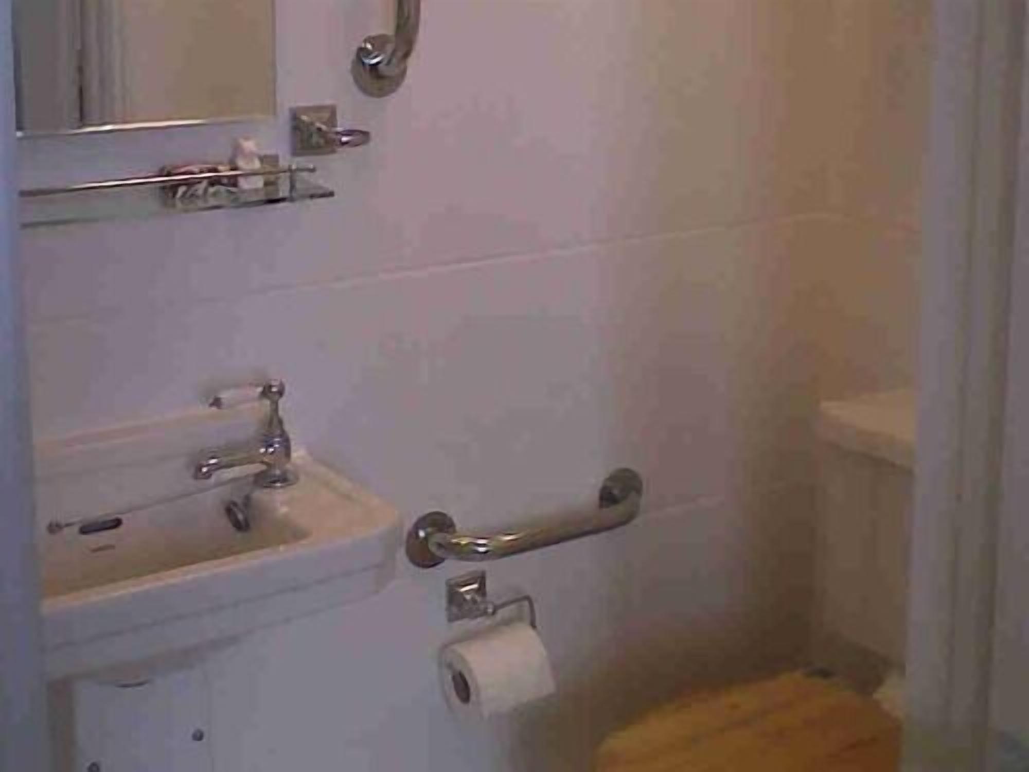 Un baño con lavabo, inodoro y espejo.